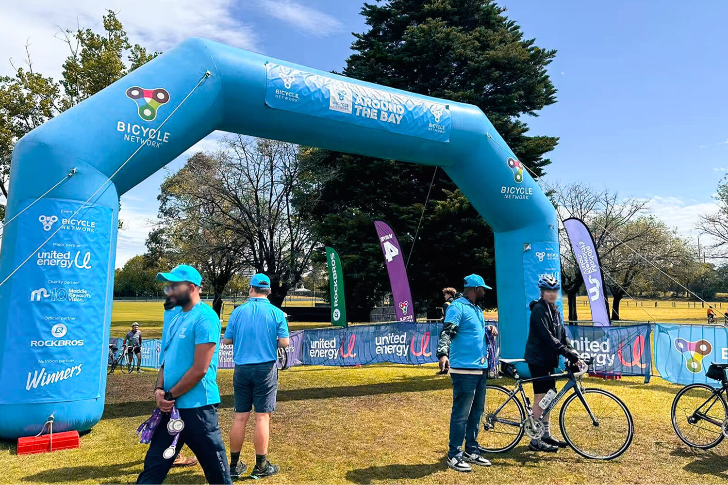 Cyclists riding through the rain during the 2025 United Energy Around the Bay event in Melbourne.