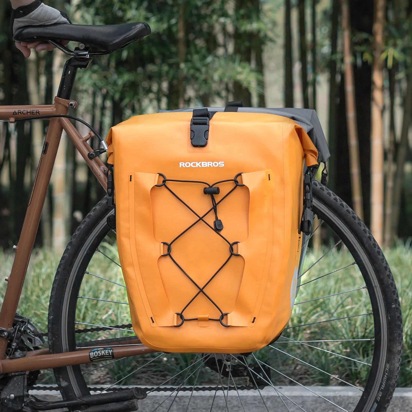 ROCKBROS 25L waterproof bike pannier bag installed on bicycle rear rack for touring and commuting.
#color_orange