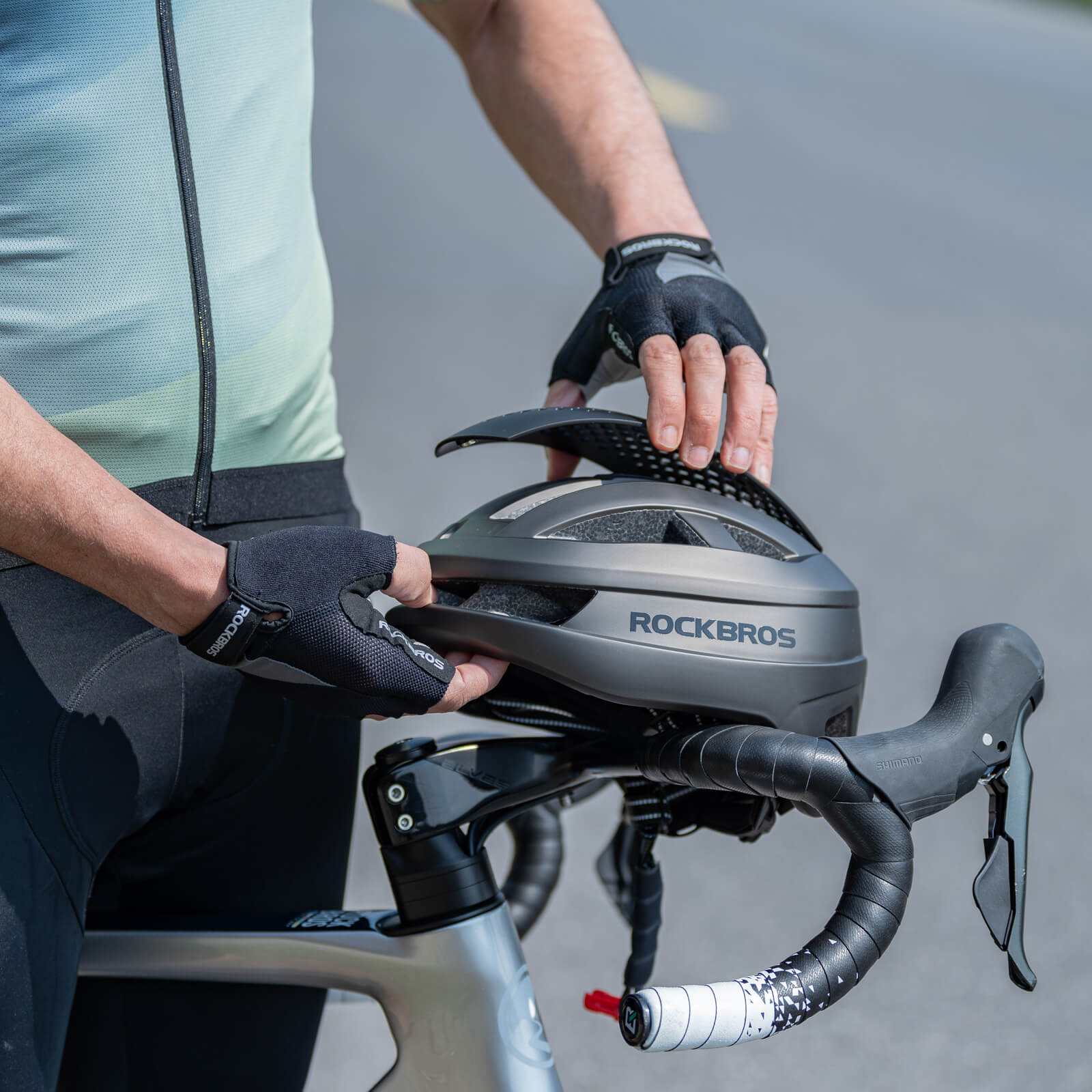 Cyclist wearing ROCKBROS Andre Leducq AeroSwitch Magnetic Helmet during ride.