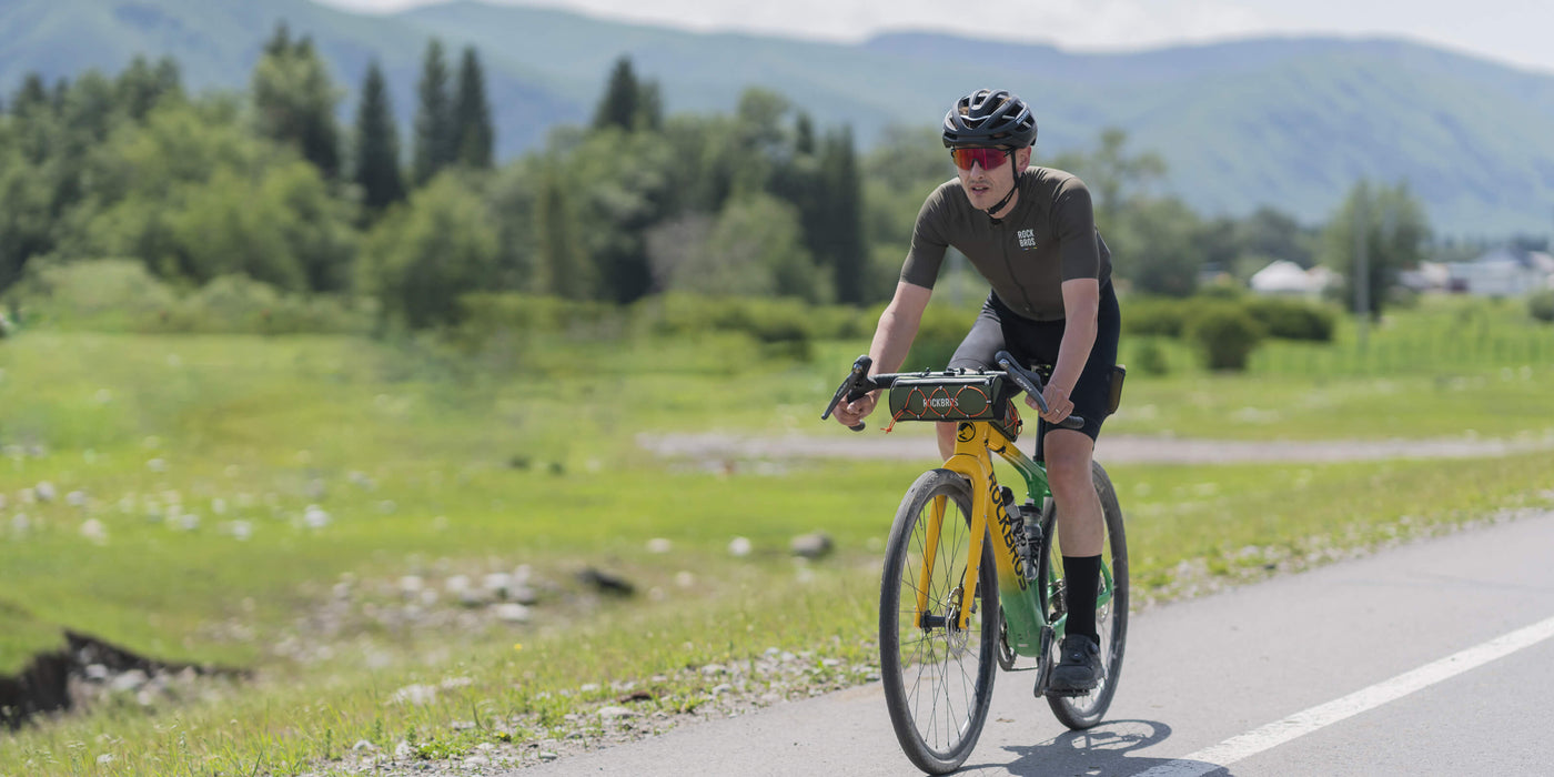 spring cycling gear banner with rider and outdoor adventure scene
